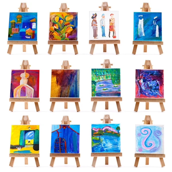 Twelve mini paintings on easels isolated on white — Stock Photo, Image