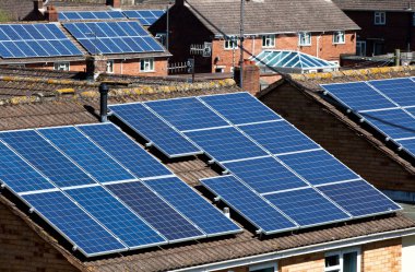 Solar Panels on many residential roofs clipart