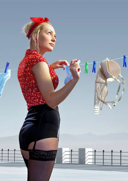 Frau hängt gewaschene Unterwäsche aus — Stockfoto