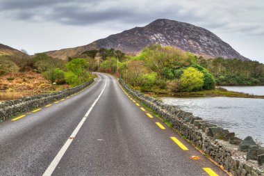Irish road with mountain view clipart
