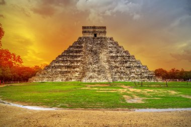 Kukulkan pyramid in Chichen Itza at sunset clipart