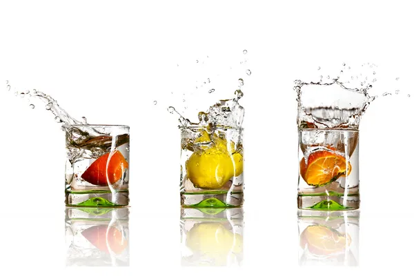 Drinks with splashing citrus fruits Royalty Free Stock Photos