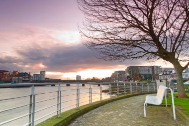 Empty bench at Shannon river clipart