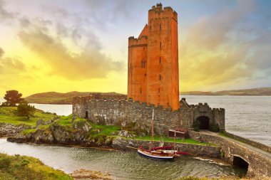 Kilcoe castle at sunset clipart