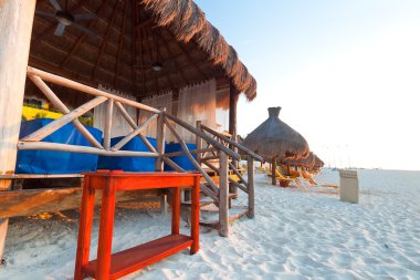 Massage hut on Caribbean beach clipart