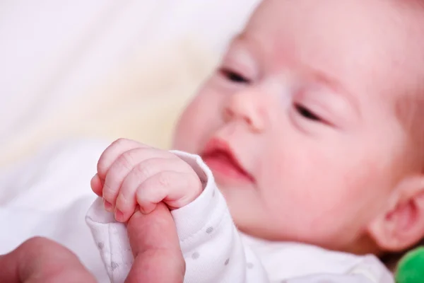 Menina bebê segurando o dedo de sua mãe — Fotografia de Stock