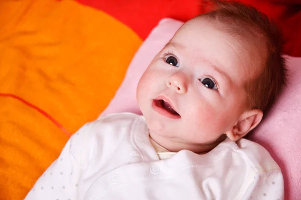 Baby girl lying on a soft blanket and watching — Stock Photo, Image