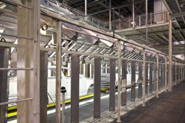 Cars in a row at car plant clipart