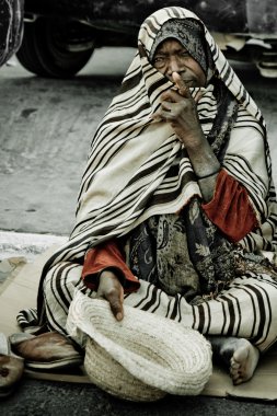 Homeless man on the street in Midoun, Djerba, Tunisia clipart