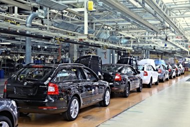 Assembling cars Skoda Octavia on conveyor line clipart