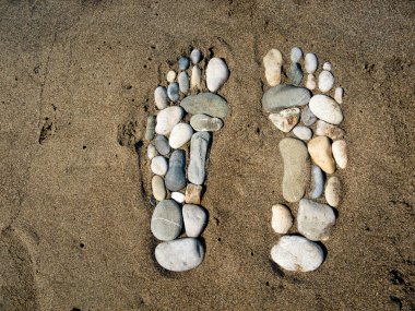 Stone feet in the sand clipart