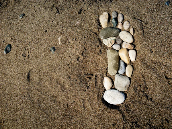 Steinfuß im Sand — Stockfoto