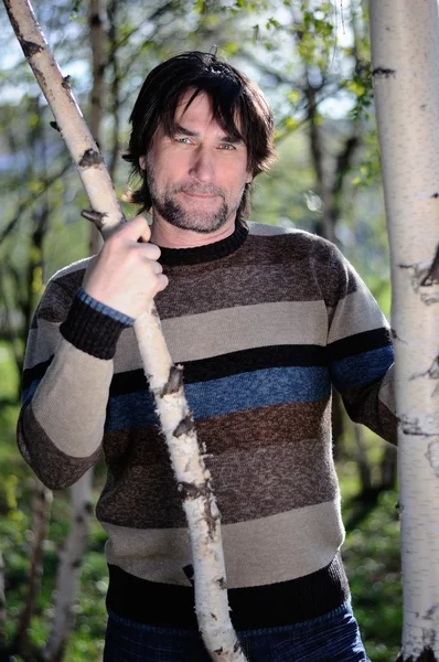 Middle-aged man in a birch grove — Stock Photo, Image