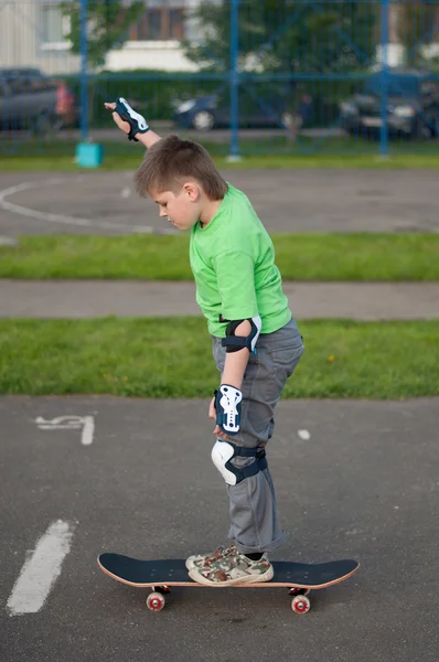 Um menino montando um skate — Fotografia de Stock