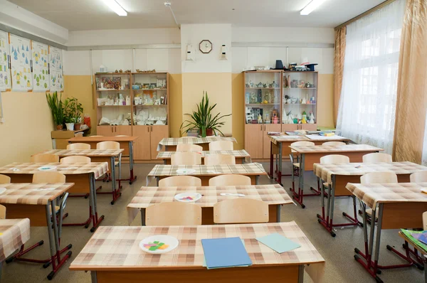 Klassenzimmer vor dem Unterricht, Schreibtische sind mit Öltuch abgedeckt — Stockfoto
