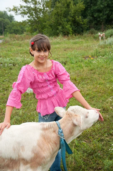 Village life. Girl with a calf — Stock Photo, Image
