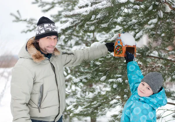 Stock image Dad, son and feeding for birds in winter