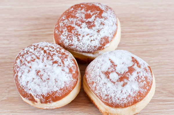 Donuts sprinkled with powdered sugar — Stock Photo, Image