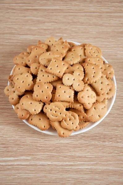 Children figured crackers on a plate — Stock Photo, Image