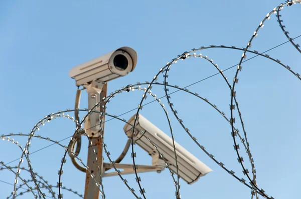 stock image Camera surveillance and barbed wire