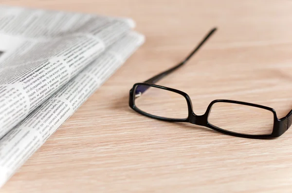 stock image Eyeglasses lying around newspapers