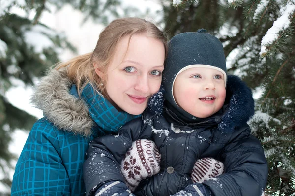 Mother and son in a spruce forest — Stock Photo, Image