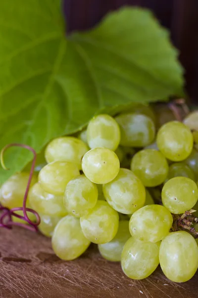 Bando de uvas em fundo de madeira — Fotografia de Stock