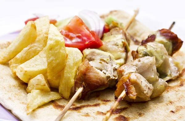 stock image Shish kebab(greek souvlaki) with fried potato and salad