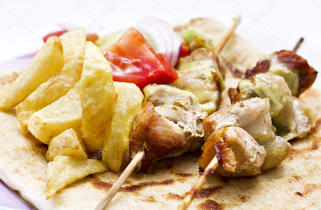 Shish kebab(greek souvlaki) with fried potato and salad