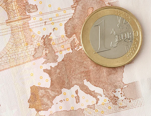 stock image One Euro Coin on Euro Banknote showing Map of Europe