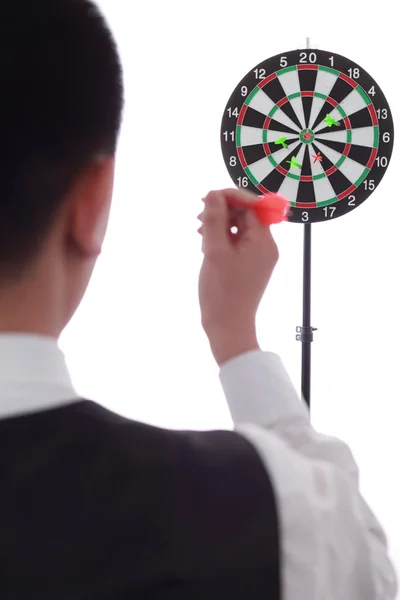 A man is tossing a dart on the target. — Stock Photo, Image