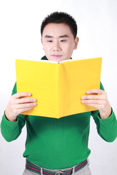 Student reading a book with a white background.