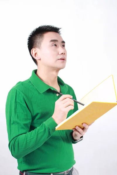 Student reading a book with a white background. Stock Image