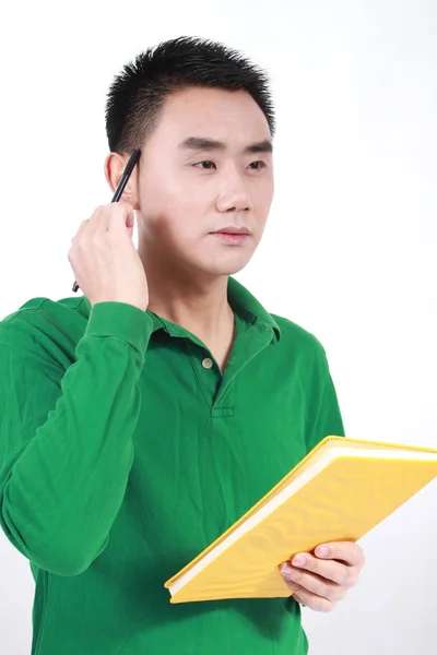 Student reading a book with a white background. Stock Photo