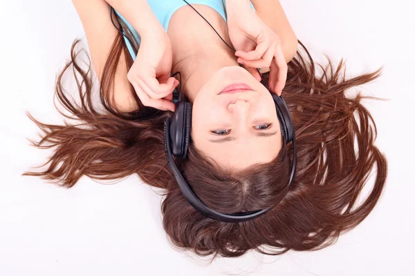 stock image Nice teen girl lying on floor in earphones