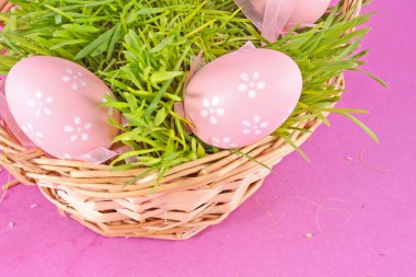 Colorful painted easter eggs in basket clipart