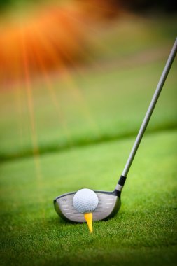 Macro shot of a golf club ready to drive the ball clipart