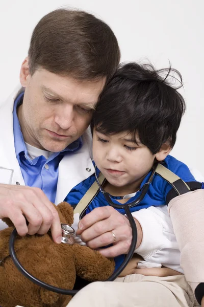 Male doctor interacting with disabled toddler patient on lap — Stock Photo, Image