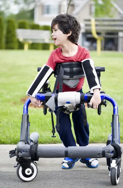 Vijf-jarige gehandicapte jongen in walker door park. Hij heeft cerebrale pa — Stockfoto