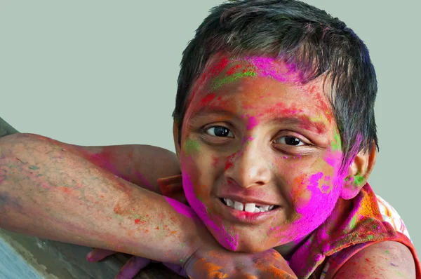 stock image Close up face of young boy playing Holi, smiling colors, white B