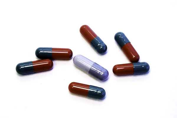 Pills in capsules at white blank Stock Photo