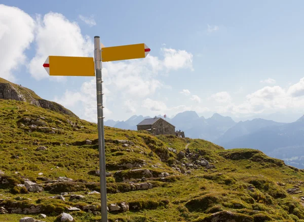 Hiking signpost and guesthouse, Switzerland — Stock Photo, Image