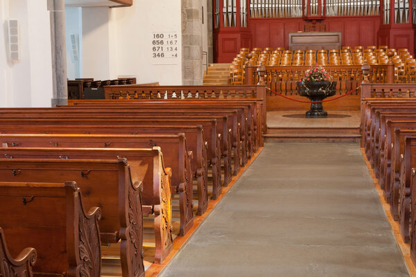 Rows of empty wooden church benches
