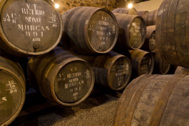 Port wine ages in barrels in cellar clipart