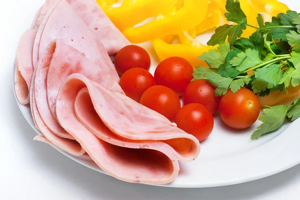 Some ham slices on plate with tomatoes and parsley — Stock Photo, Image