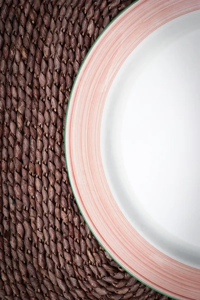 棕色柳条背景上的空盘子 — 图库照片