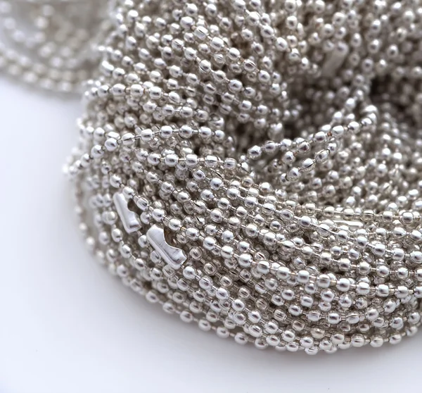 A lot of chain of beads lie along — Stock Photo, Image