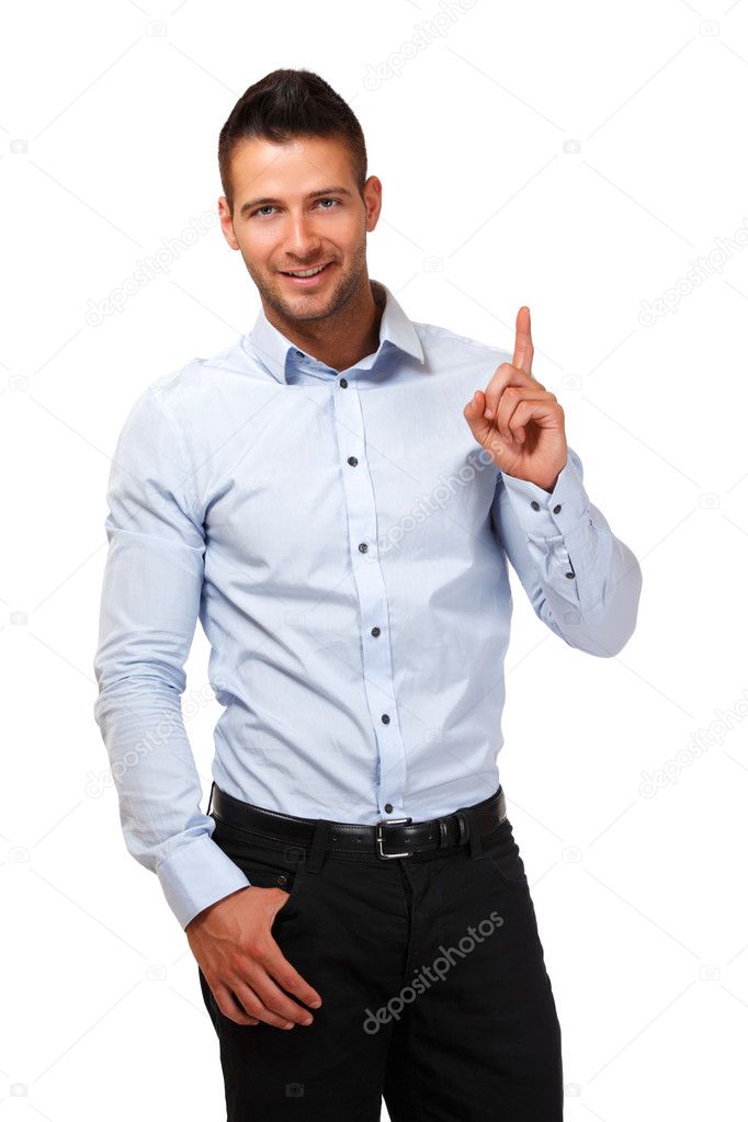 Handsome businessman pointing at copyspace