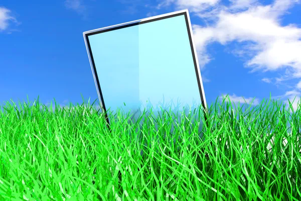 Tablet pc in het gras — Stockfoto