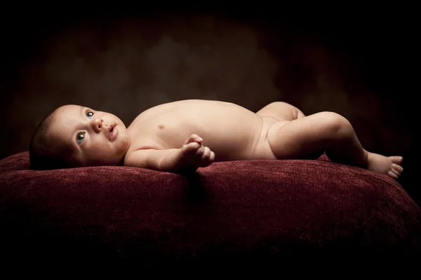 Beautiful Baby Looking Up Lays on Pillow — Stock Photo, Image